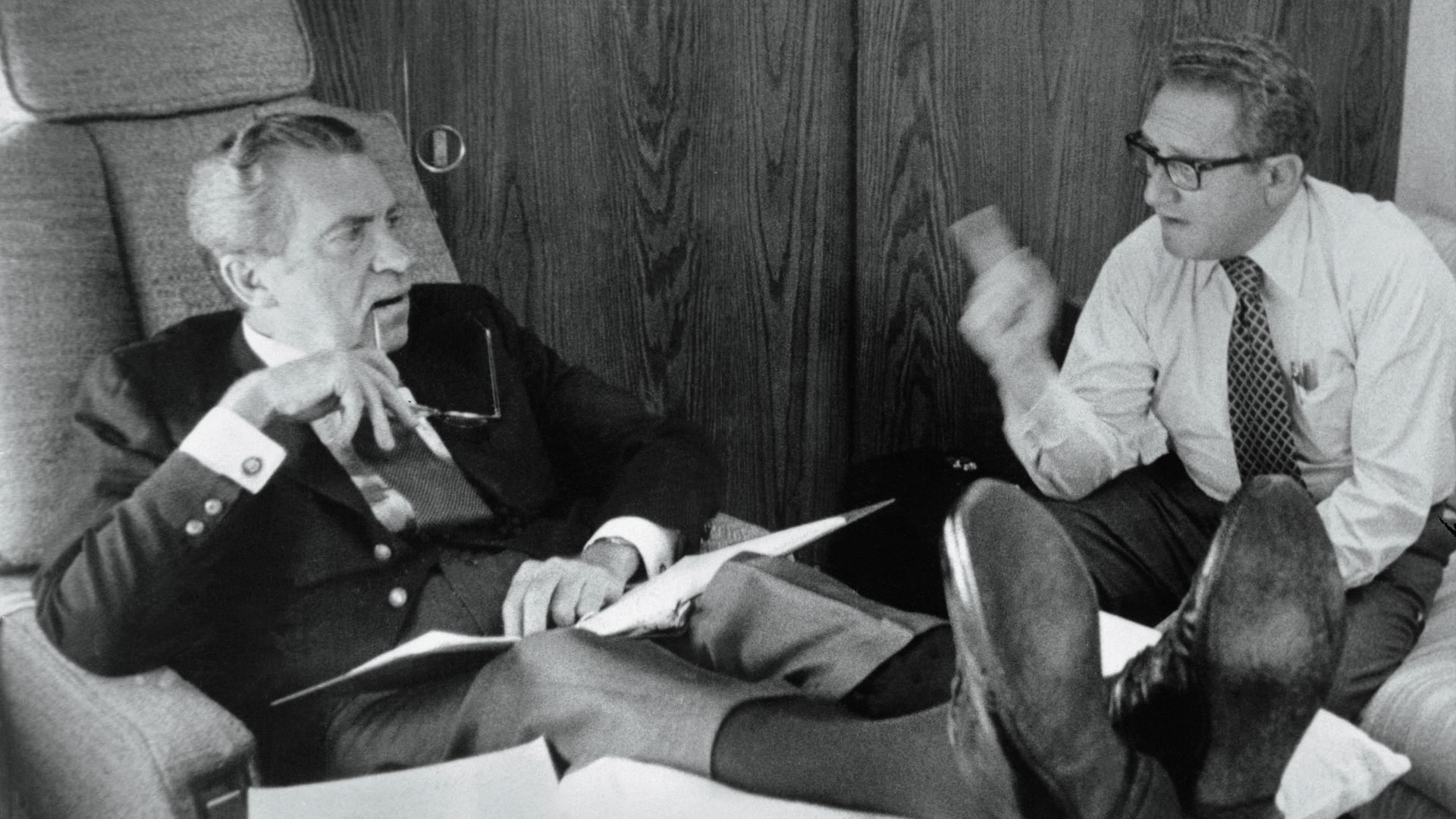 President Richard Nixon and secretary of state Henry Kissinger confer aboard Air Force One (Credit: Bettmann/Getty) 