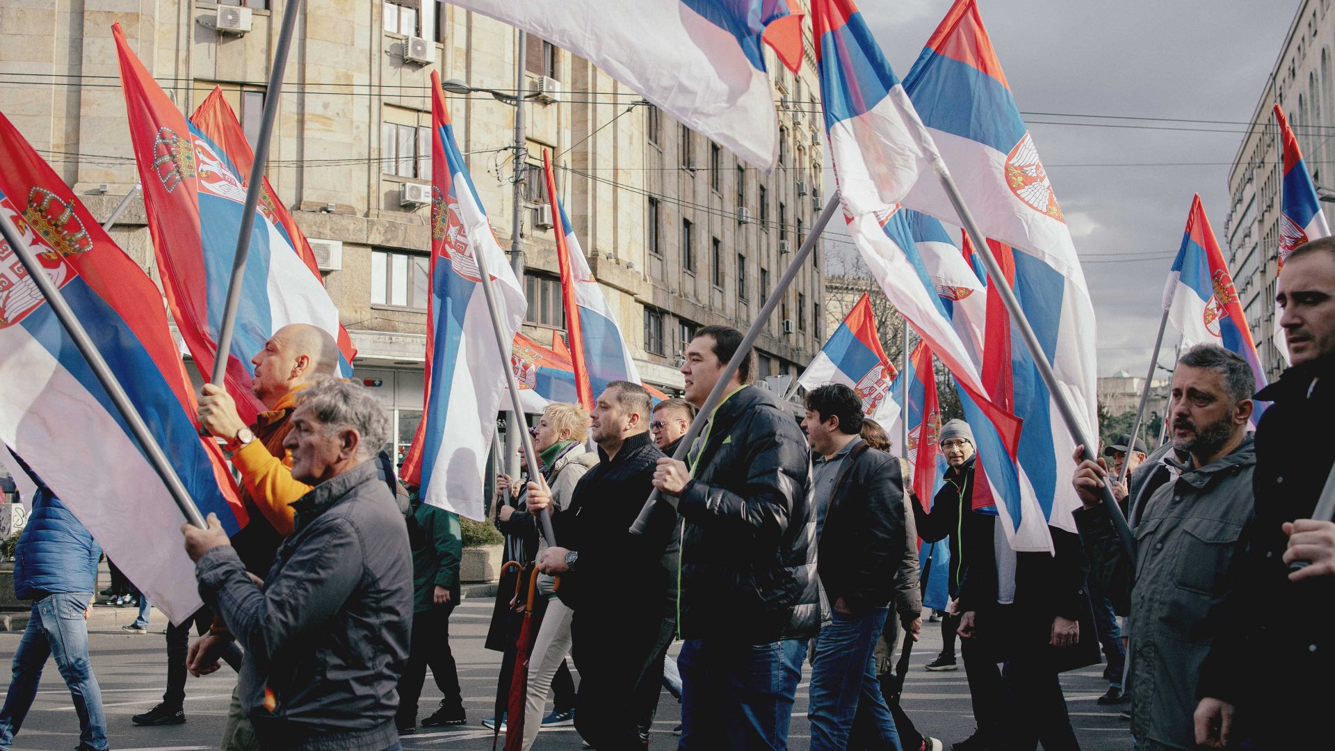 People wave Serbian flags, as they attend a protest organised by ProGlas. Photo: Vladimir Zivojinovic/Getty Images