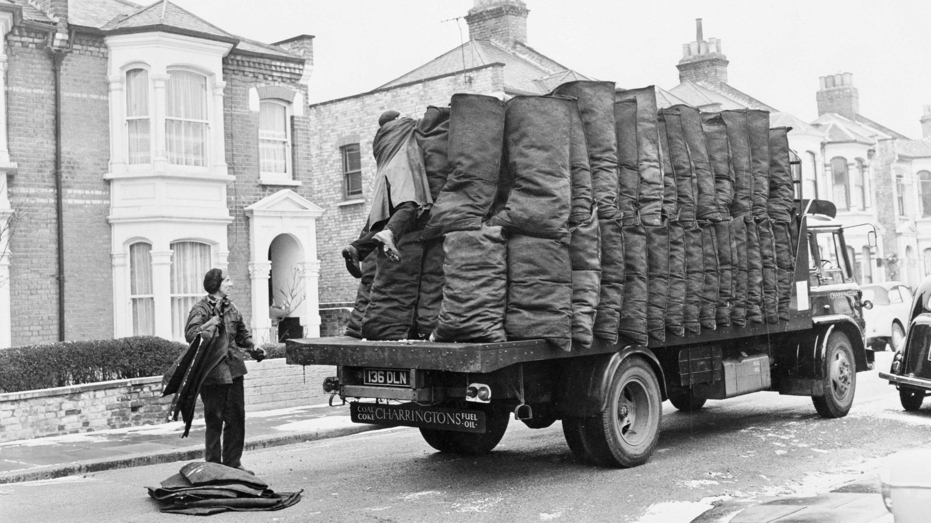 Charringtons delivering sacks of coal down a residential street (Photo by Museum of London/Heritage Images/Getty Images)