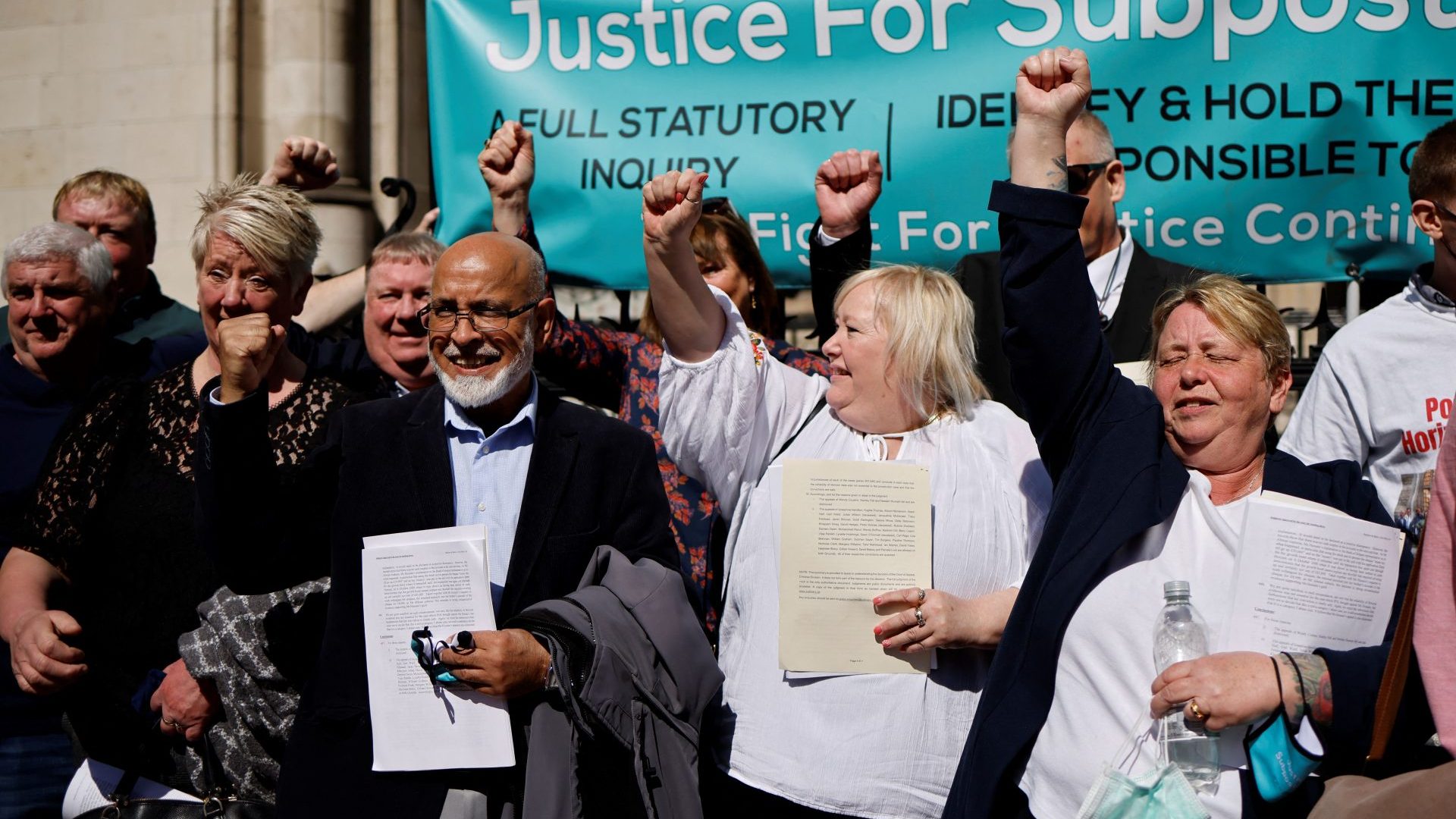 Former subpostmasters celebrate outside the Royal Courts of Justice in London, on April 23, 2021, following a court ruling clearing subpostmasters of convictions for theft and false accounting. Photo: TOLGA AKMEN/AFP via Getty Images