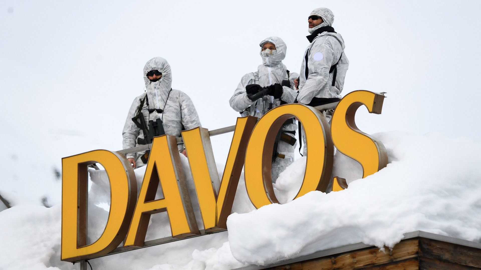 Armed security men stand guard on top of a hotel in Davos, where the great and not-so-good will gather for the annual forum. Photo: Fabrice Coffrini/AFP/Getty