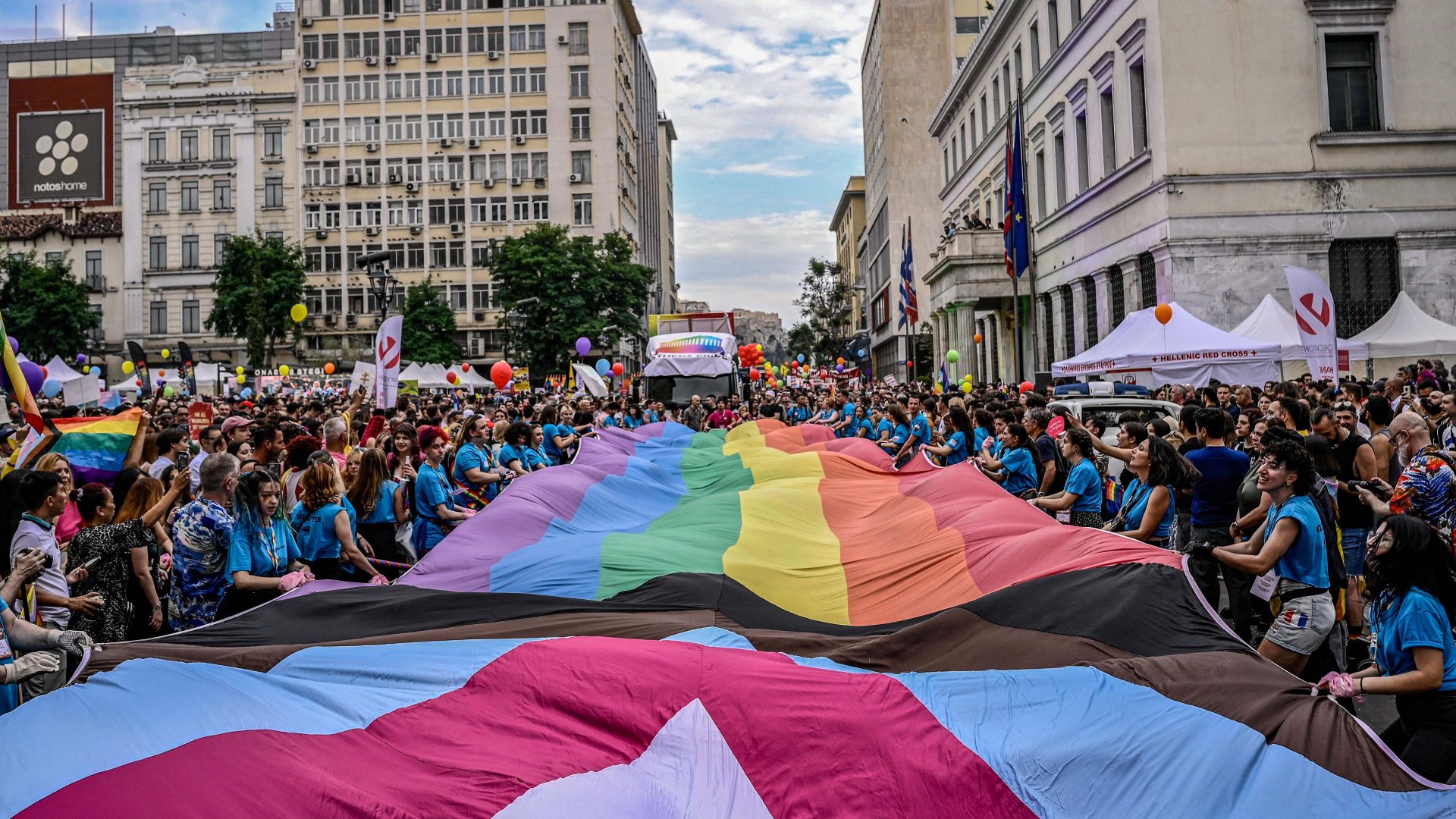 Participants hold a giant rainbow flag during the Athens Pride parade in Athens. Photo: Spyros BAKALIS / AFP