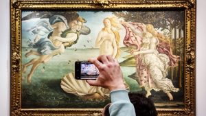 Visitors photograph The Birth of Venus (Nascita di Venere) by the 15th-century Italian Renaissance artist Sandro Botticelli at the Uffizi Gallery in Florence. Photo: David Silverman/Getty