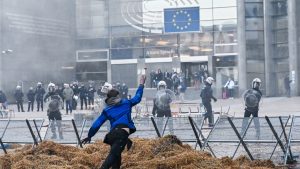 Protesters throw eggs at police outside the European Parliament during protests by farmers. Photo: Dirk Waem/Belga/AFP/Getty