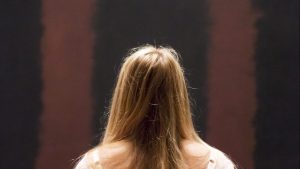 A woman looks at Mark Rothko’s Black on Maroon (1958) after going back on display at Tate Modern in 2013,
18 months after it was vandalised. Photo: Rob Stothard/Getty