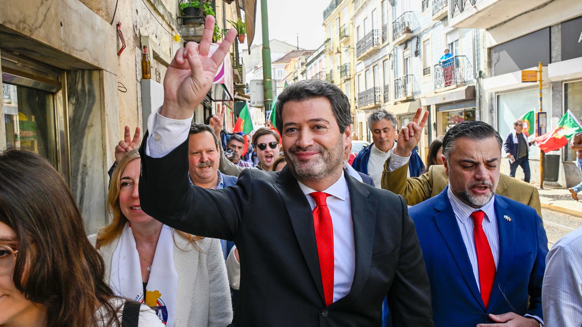 "Chega" Far-Right Party Leader André Ventura gives a victory sign to people during a campaign street parade. Photo: Horacio Villalobos Corbis/Corbis via Getty Images