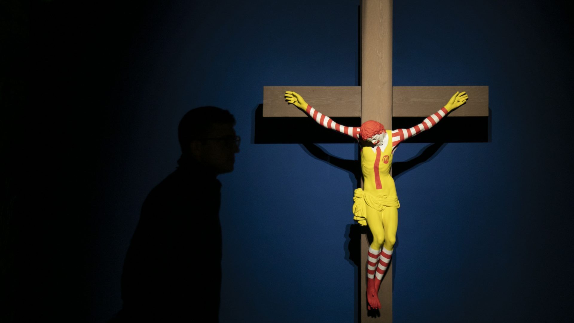 A visitor observes the work called 'McJesus' , by the artist Jani Leinonen, at the Forbidden Art Museum. Photo: Manuel Medir/Getty Images