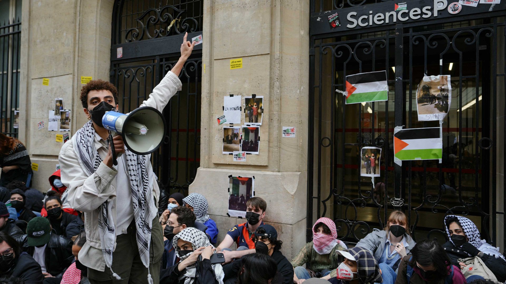 Protesters stage a sit-in in front of the entrance of the Institute of Political Studies (Sciences Po Paris) as they take part in a demonstration in front of the building occupied by students, in support of Palestinians. Photo: DIMITAR DILKOFF/AFP via Getty Images