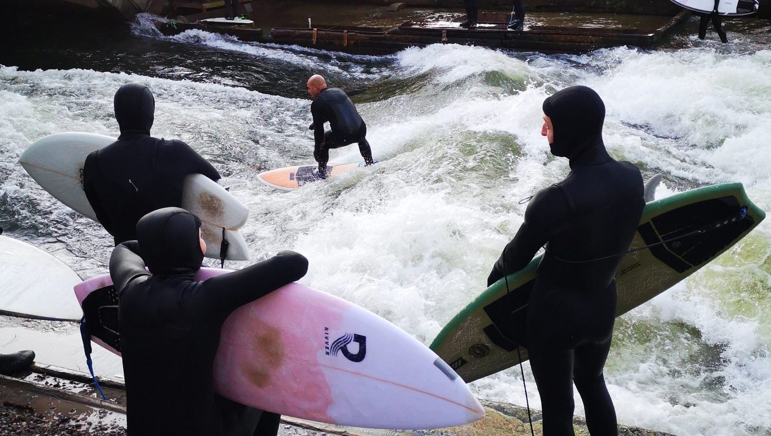 Intrepid surfers ride the wave on the Eisbach River in the heart of Munich. Photo: Deborah Nash