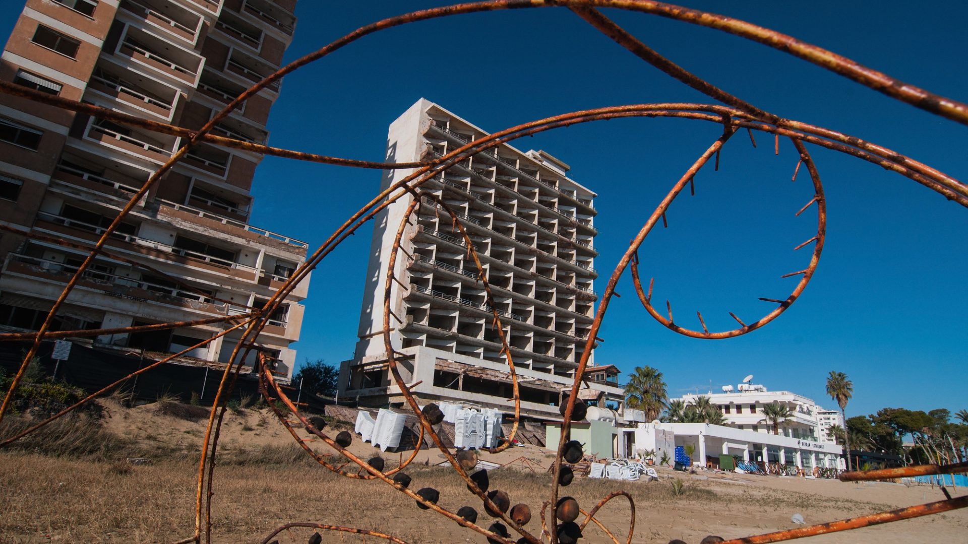 Barbed wire and an abandoned hotel in the Varosha quarter of Famagusta, Cyprus. Prior to the Turkish invasion in 1974, Varosha was one of the world’s most important tourist destinations. Photo: Awakening/Getty
