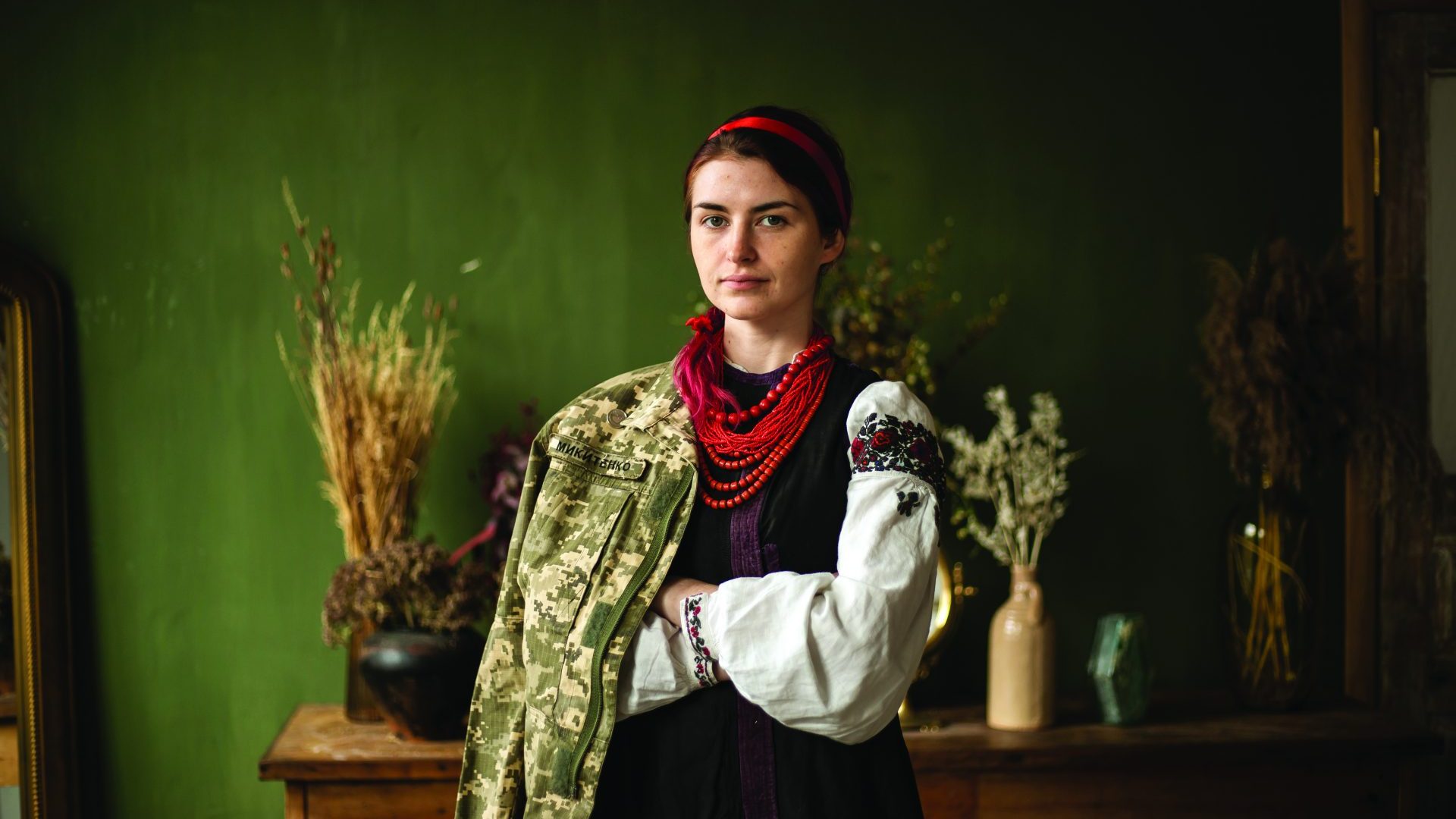 Yulia Mykytenko in traditional Ukrainian dress and her army uniform. Photo: Anastasia Olijnyk for the Ultimate Ukrainian Magazine 2021. Courtesy of Spilna Mova, LLC