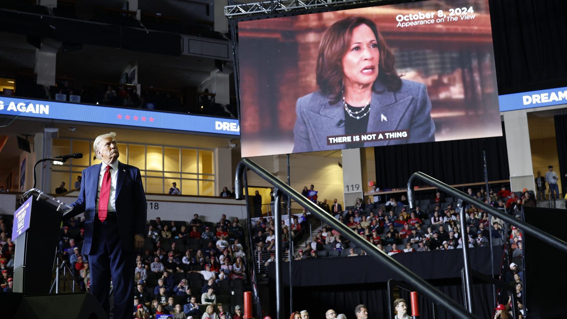 Donald Trump looks toward a video clip of Kamala Harris at a campaign rally in Pennsylvania on October 29 (Photo by Chip Somodevilla/Getty Images)
