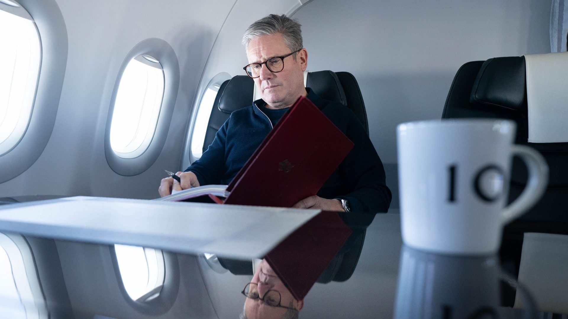 Sir Keir Starmer works during a flight to Brazil to attend the G20 summit. Photo: Stefan Rousseau/Getty