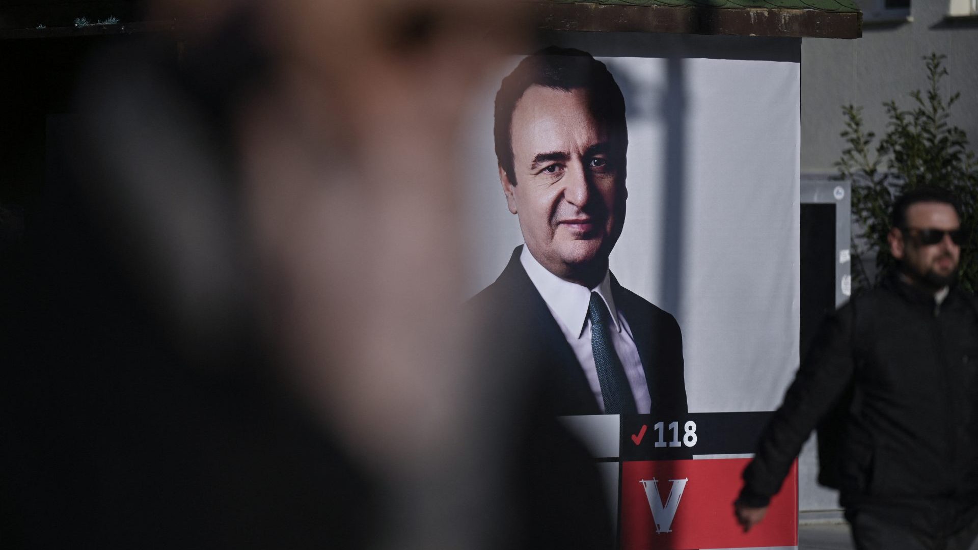 A man walks past a billboard depicting Kosovo's current Prime Minister Albin Kurti. Photo: ARMEND NIMANI/AFP via Getty Images