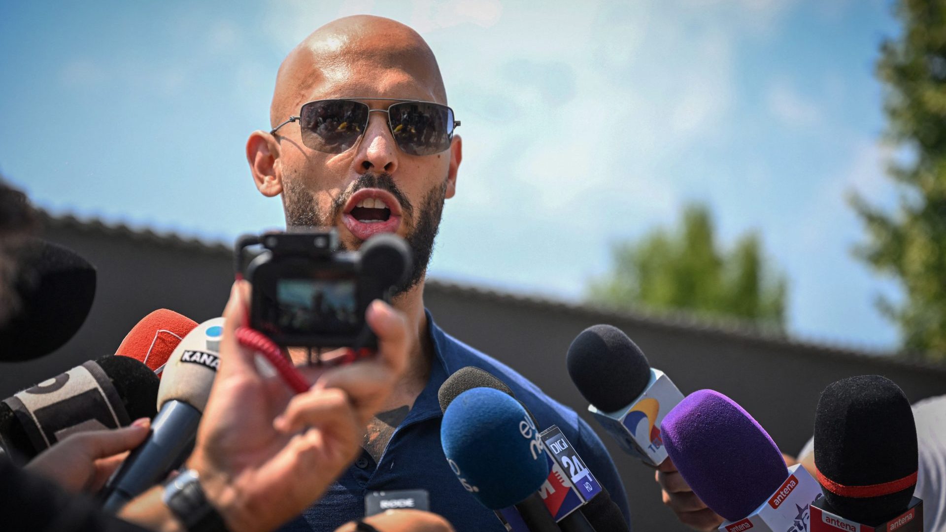 Andrew Tate addresses the media in the front of his former home in Bucharest. Photo: DANIEL MIHAILESCU/AFP via Getty Images