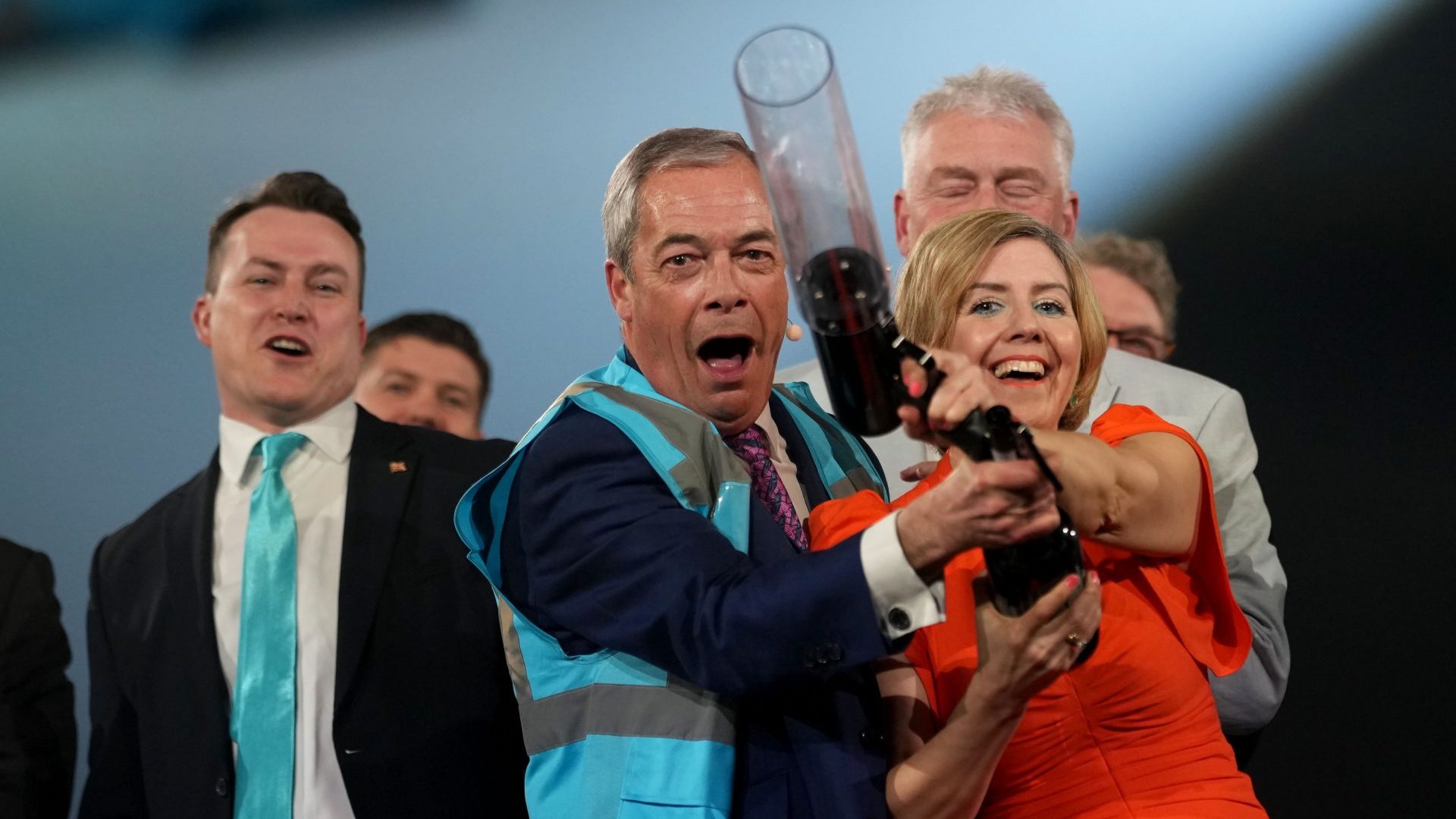 Nigel Farage and Reform UK mayoral candidate Andrea Jenkyns fire high visibility jackets into the crowd during rally. Photo: Christopher Furlong/Getty Images
