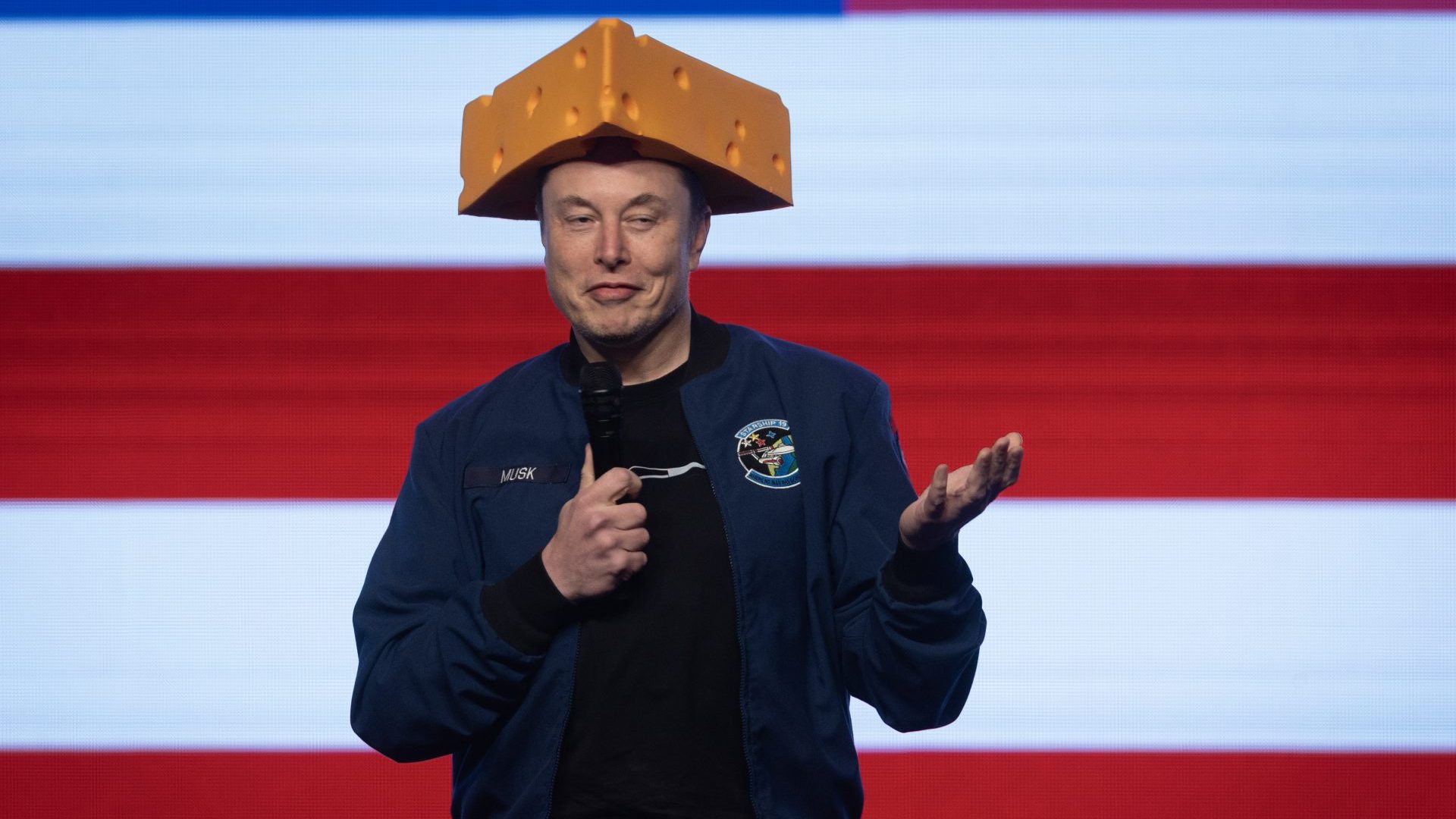 Elon Musk arrives for a town hall meeting in Wisconsin wearing a cheesehead hat. Photo: Scott Olson/Getty Images